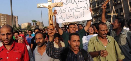 Protesters holding a crucifix and signs during a religious demonstration in Egypt.